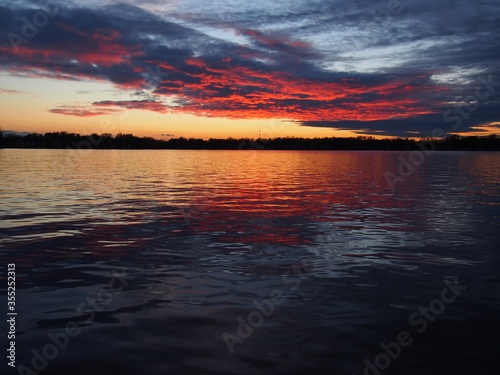 Michigan boaters enjoying a peaceful sunset on Lake Lansing in Haslett  Mi