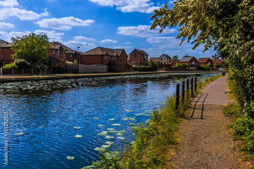 A view along the towpath in a residential area beside the Birmingham Canal in summertime photo