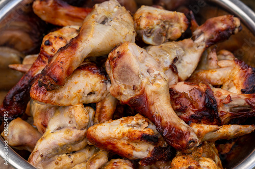 Juicy grilled chicken legs and wings. Close-up.