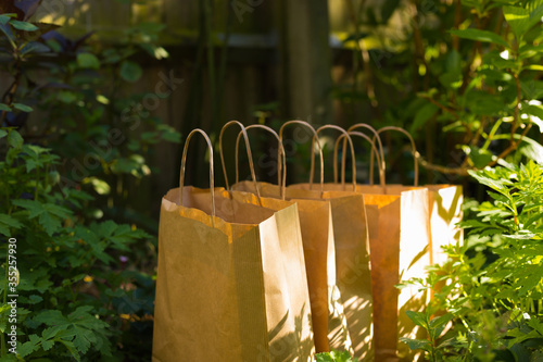 Delivery of Natural Foods. Several Eco Recycle Shopping Bags with Organic Farm Products are Outside on a Sunny Day. 