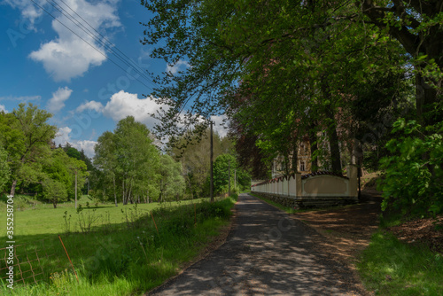 Old family house with towers and long color wall near Podhradi village