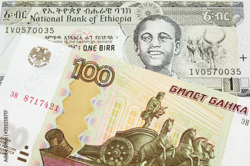 Wallpaper Mural A macro image of a Russian one hundred ruble note paired up with a grey Ethiopian one birr bill.  Shot close up in macro. Torontodigital.ca