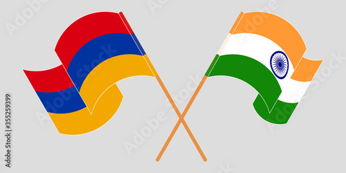 Crossed and waving flags of Armenia and India photo