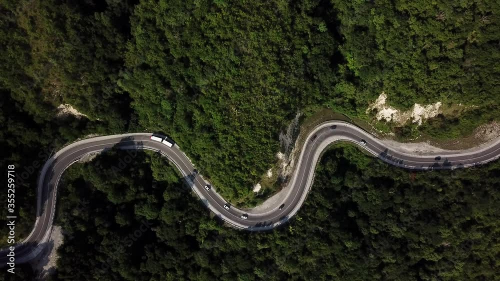 Mountain winding zig zag road. Top aerial view: cars driving on road from above. Mountain winding zig zag road. Top aerial view: cars driving on road from above.