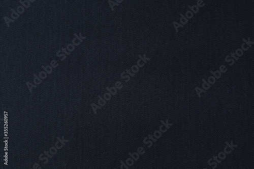Elegant blue woolen fabric striped zigzag. Herringbone tweed, Wool Background Texture. Coat close-up. Expensive men's suit fabric. High resolution. Gray herringbone woolen fabric, smooth background