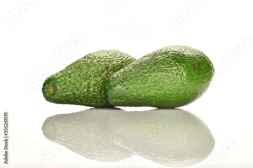 Green fresh ripe tasty avocado, close-up, on a white background.