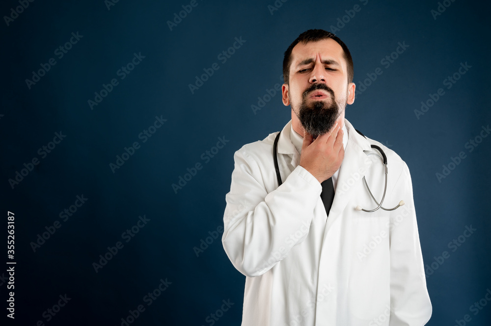 Male doctor with stethoscope in medical uniform has sore throat Male doctor with stethoscope in medical uniform has sore throat