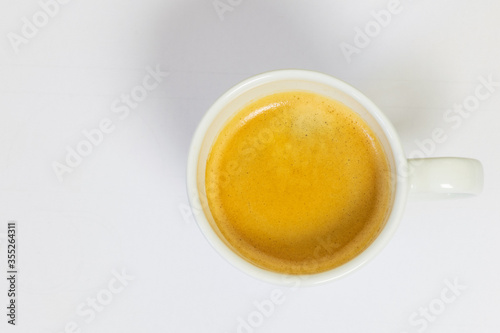 White cup of coffee from the zenith on white background