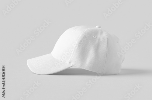 Canvas Print White baseball cap mockup on a grey background, side view.