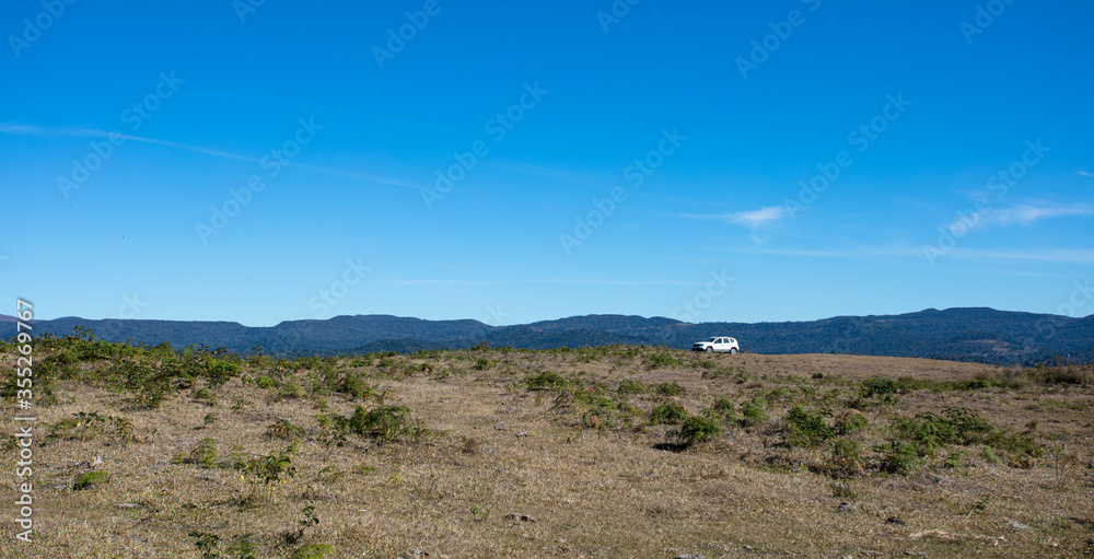 Paisagem de pradaria com carro branco Paisagem de pradaria com carro branco