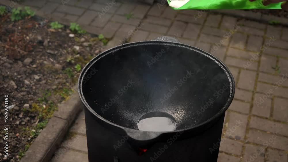 A man cooks fried meat in a pan with sauce and beer. 4K shooting A man cooks fried meat in a pan with sauce and beer. 4K shooting