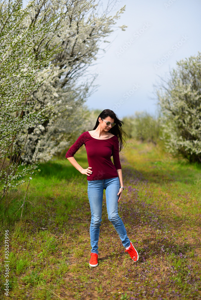 Brown hair girl in sunglasses on the flower meadow Brown hair girl in sunglasses on the flower meadow