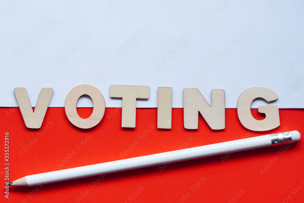 President voting wooden letters inscription-translation wybory-in Poland on coronavirus pandemia time. Politician flatly on white-red polish flag with pencil. Political elections.