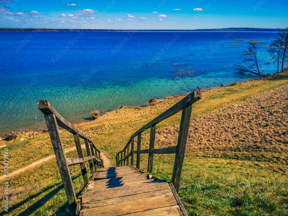Obraz premium Stairs on mound with Ancient Settlement on the shore of lake Metelys, Lithuania