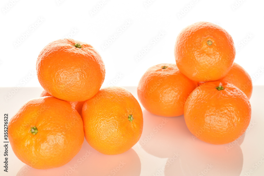 Bright yellow juicy, fresh, organic tangerines, close-up, on a white background. Bright yellow juicy, fresh, organic tangerines, close-up, on a white background.
