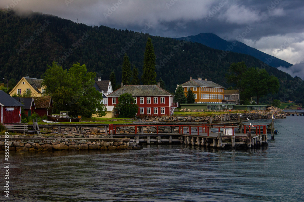 Beautiful houses on the shore of the fjord in Balestrand. Norway