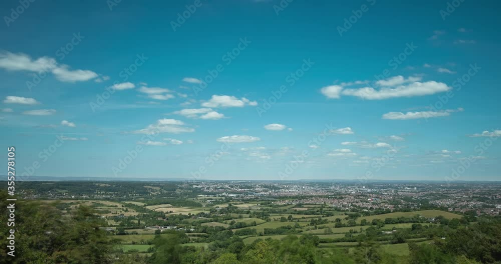 Time lapse of clouds over distant town in England countryside Time lapse of clouds over distant town in England countryside