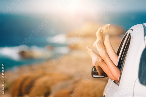 Closeup of little girl feet showing from car window