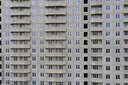 Aerial view of a tall residential apartment building with many windows and balconies.