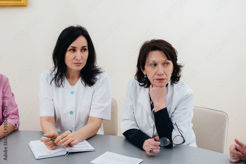 Fototapeta premium Meeting of doctors in the clinic about the virus epidemic. Virus, and epidemic, quarantine