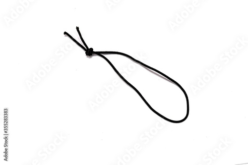 Black elastic band with knots isolated on white background photo