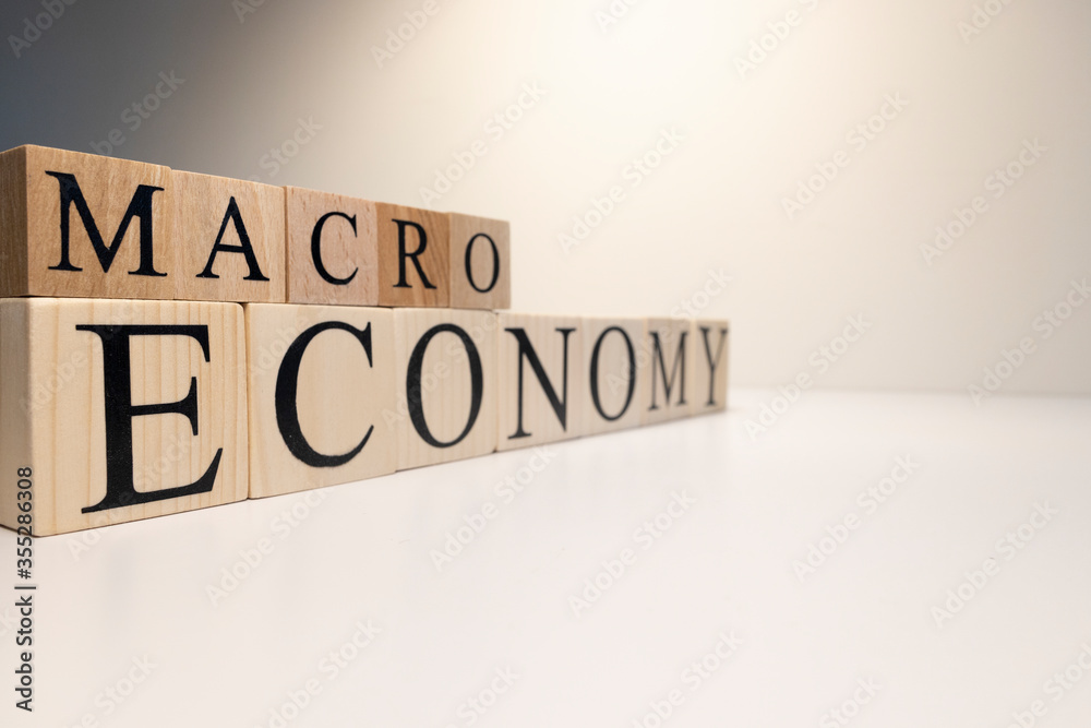 Business concept. Macro, economy, risk words are written with wooden cubes. Business concept. Macro, economy, risk words are written with wooden cubes.