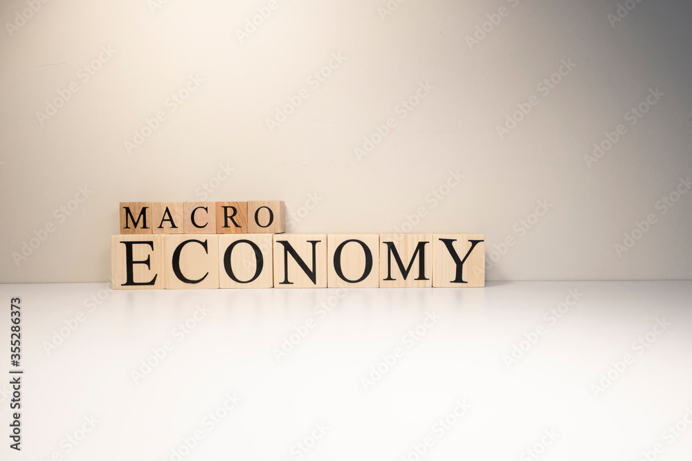 Business concept. Macro, economy, risk words are written with wooden cubes. Business concept. Macro, economy, risk words are written with wooden cubes.