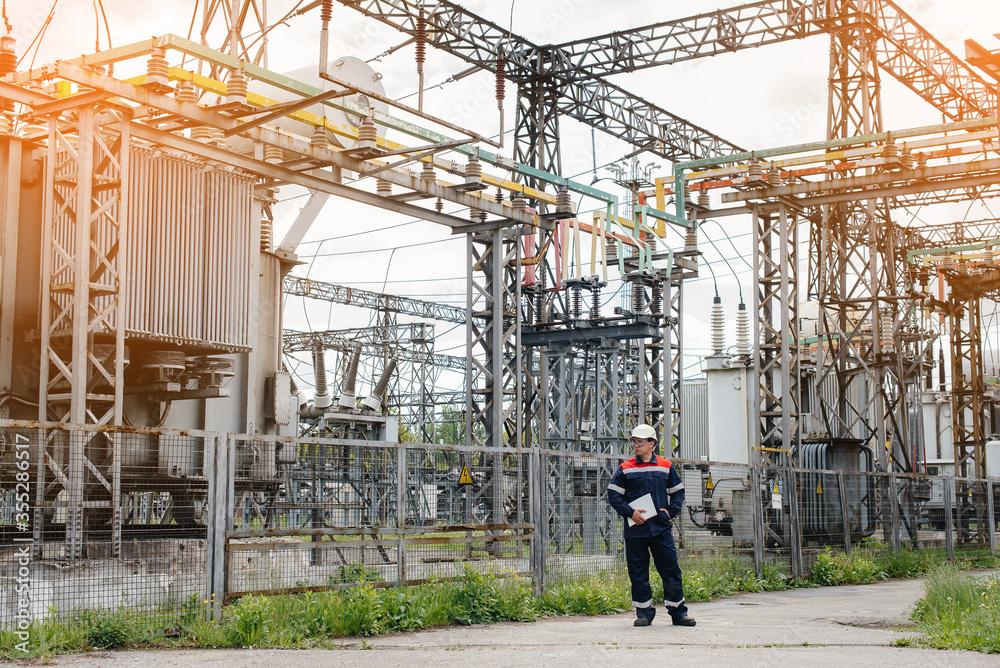 The energy engineer inspects the equipment of the substation. Power engineering. Industry