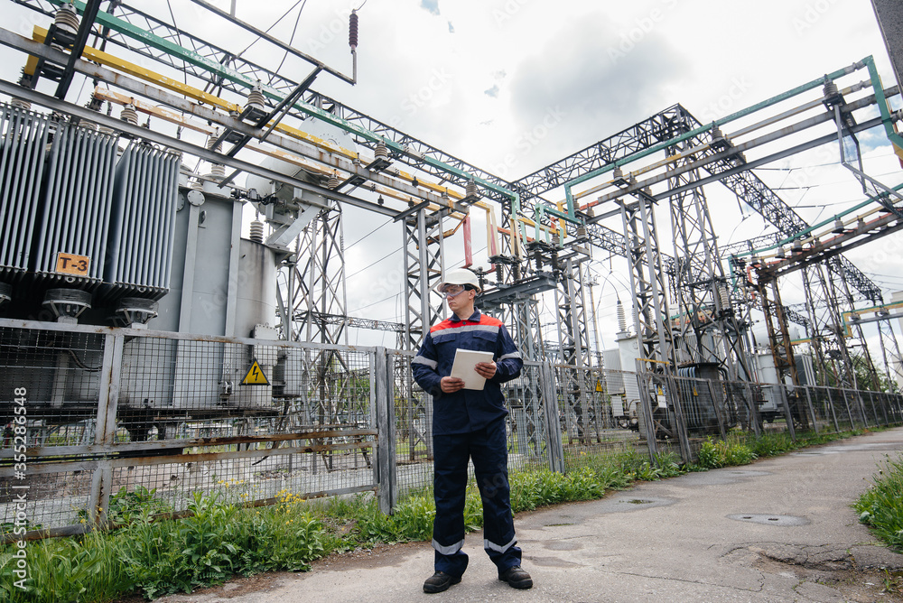The energy engineer inspects the equipment of the substation. Power engineering. Industry The energy engineer inspects the equipment of the substation. Power engineering. Industry