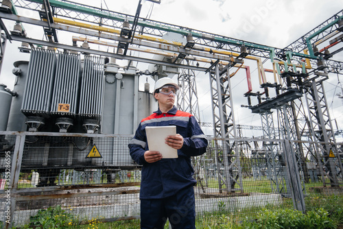 The energy engineer inspects the equipment of the substation. Power engineering. Industry