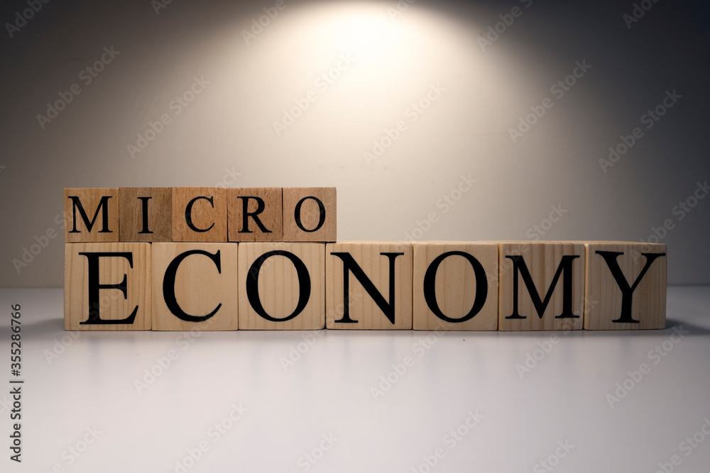 Business concept. Macro, economy, risk words are written with wooden cubes. Business concept. Macro, economy, risk words are written with wooden cubes.