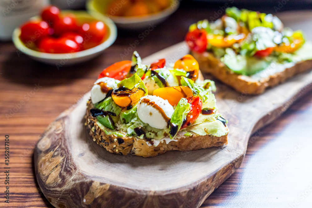 Toasts with Cherry Tomatoes, Mozzarella Cheese, Basil Leaves and Balsamic Sauce