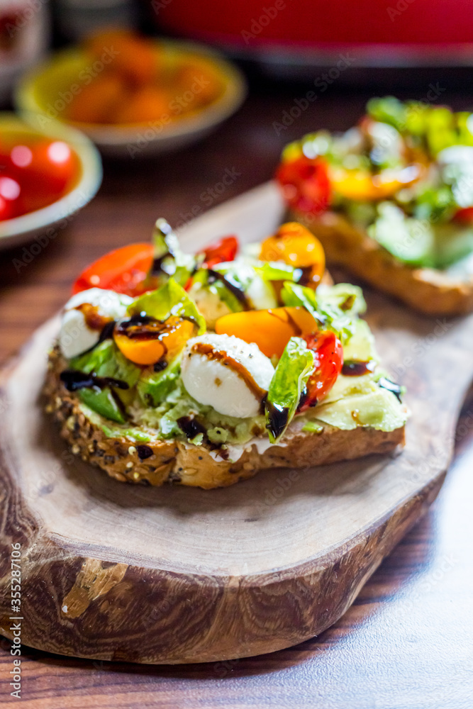 Toasts with Cherry Tomatoes, Mozzarella Cheese, Basil Leaves and Balsamic Sauce