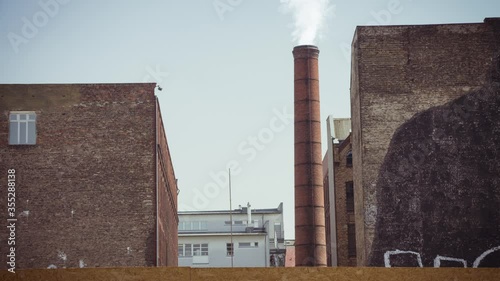 Cinemagraph of smoke emitted from an industrial brick chimney in an old factory building. It located in Berlin, Germany.Loop.