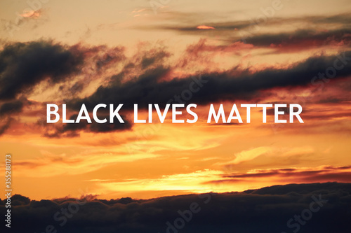 Landscape of orange evening sunset in the sky with clouds and Black Lives Matter text. The concept of racism of black people in the world, support and security