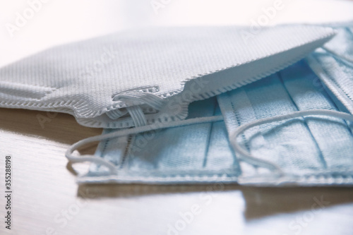 Two protective blue medical face masks on the edge of the table. The concept of safety and prevention during an epidemic of viral infection COVID-19