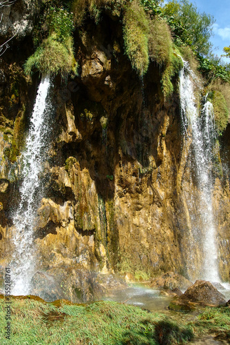 Landscape of waterfall and turquoise lake in the forest. Plitvice Lakes National Park. Nacionalni park Plitvicka Jezera  one of the oldest and largest national parks in Croatia. UNESCO World Heritage.