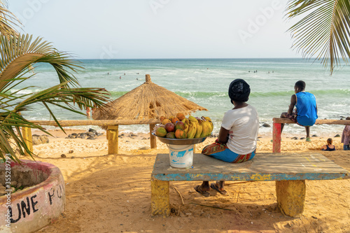 Woman selling fruit in a basket on Dakar beach in Senegal, Afrika