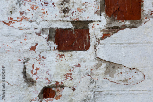 Old wall of red brick with white stucco. Background, texture