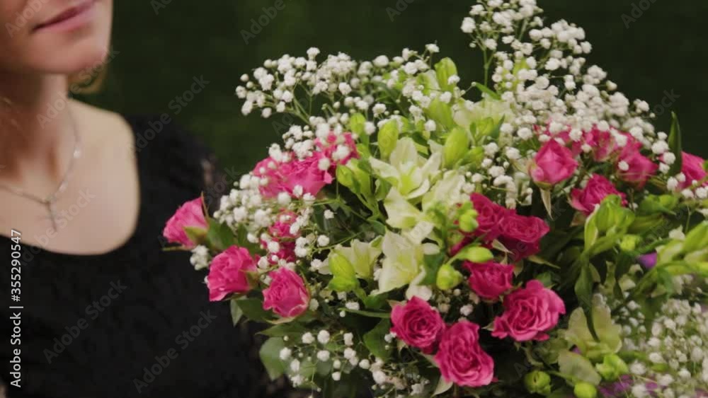 Florist holds a bouquet in her hands. Florist holds a bouquet in her hands.