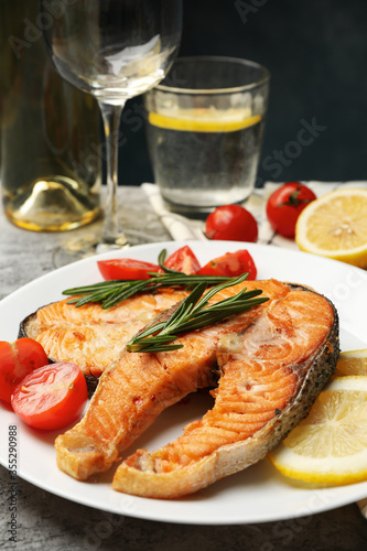 Composition with tasty grilled salmon on gray background, close up