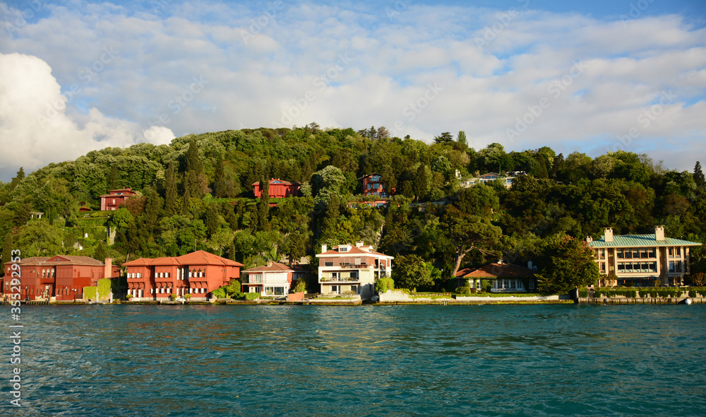City scene of buildings with mountain back and sea front in Istanbul