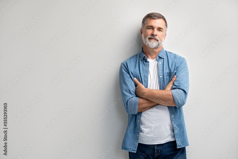 Portrait of smiling mature man standing on white background. Portrait of smiling mature man standing on white background.
