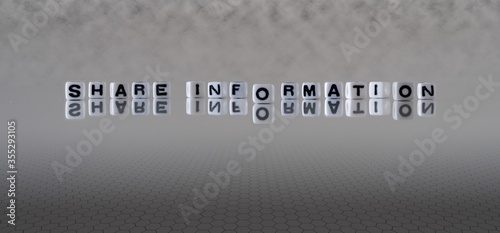 share information concept represented by black and white letter cubes on a grey horizon background stretching to infinity