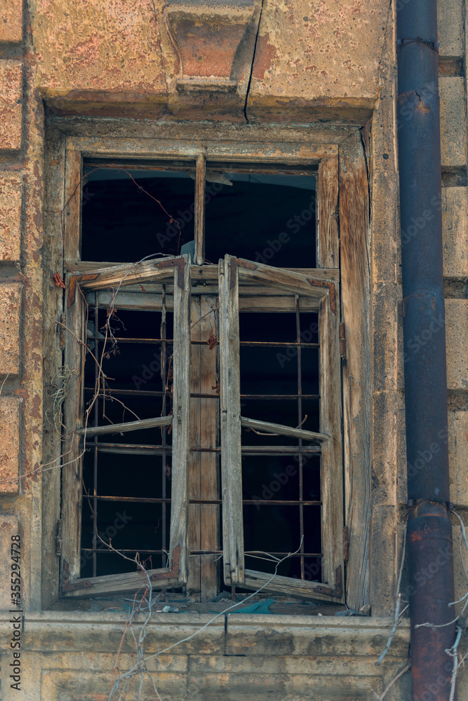 old wooden window without glass in an abandoned house close-up