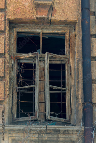 old wooden window without glass in an abandoned house close-up