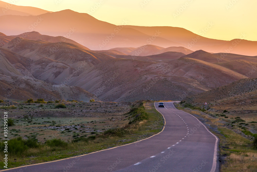 The road to the mountains. Sunset in the red mountains Khizi in Azerbaijan.