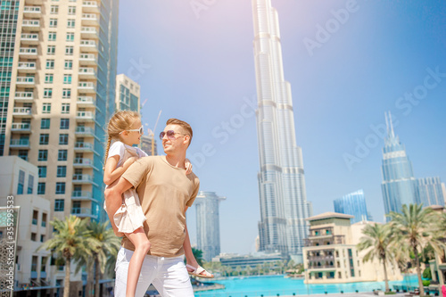 Photography Happy family walking in Dubai with skyscrapers in the background.