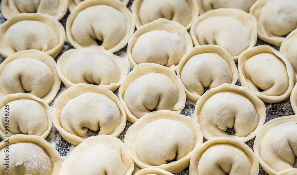 Meat dumplings russian pelmeni on wooden background Meat dumplings russian pelmeni on wooden background
