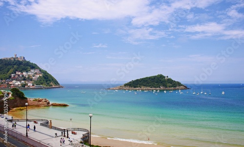Many yachts near the sandy beach in the Spanish resort town of Donostia San Sebastian in the summer of 2019